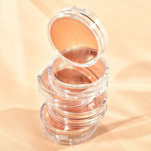 Hanskin Nudi Thin Cover Cushion SPF50+ PA+++ - Weightless Natural Foundation 12g (2 Colors) packaging stacked on a surface.
